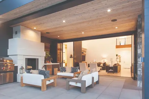 Outdoor patio furniture near fireplace and sliding glass doors