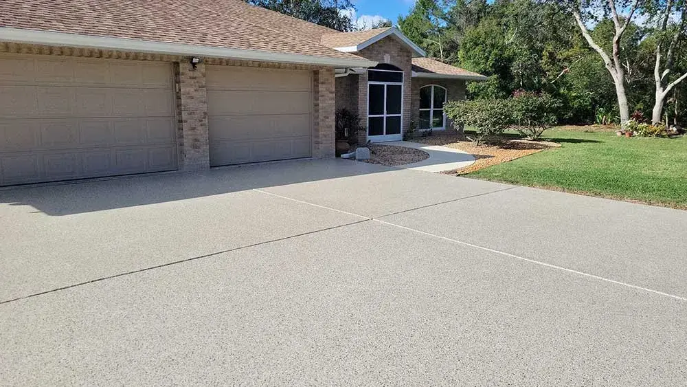 New gray driveway coating, three-car garage, home exterior