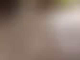 Uncoated garage floor with visible cracks, stains, and surface damage showing long-term wear