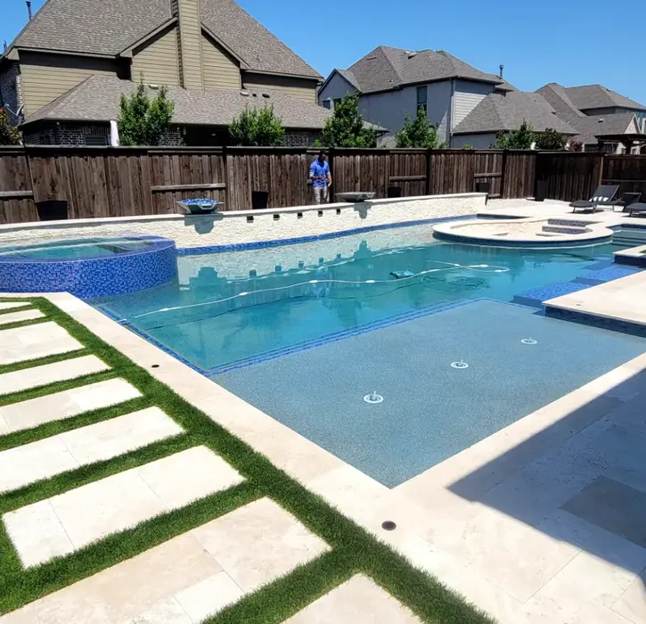 Luxury backyard pool and spa with stone pathway