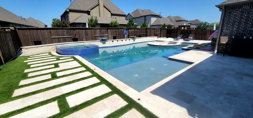 Luxury backyard pool and spa with stone pathway