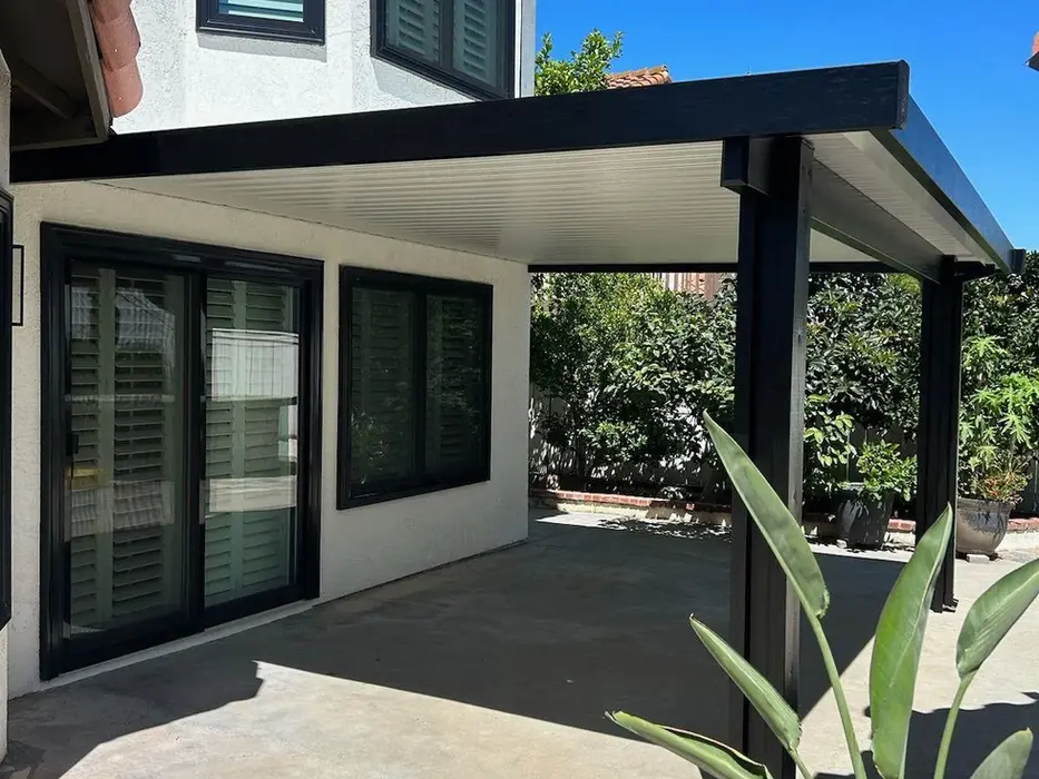 Modern black patio cover added to house