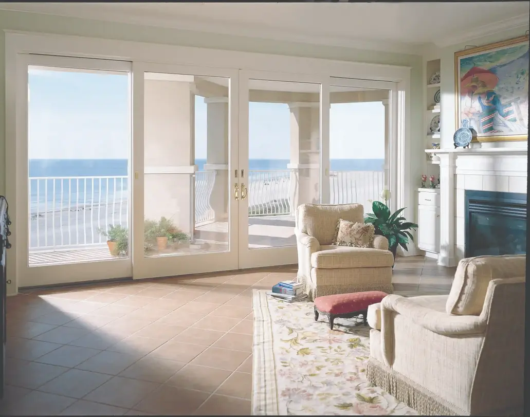 Ocean-view living room with sliding glass doors and comfy chairs