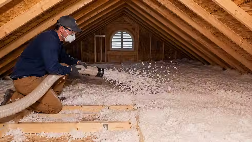 Professional attic insulation installer adding attic insulation in a DFW home before selling