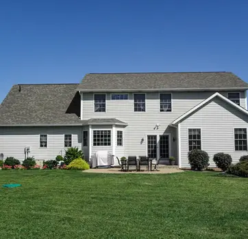 Gray two-story house with patio and yard