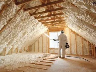 Spray foam insulation being applied in a home attic for energy efficiency