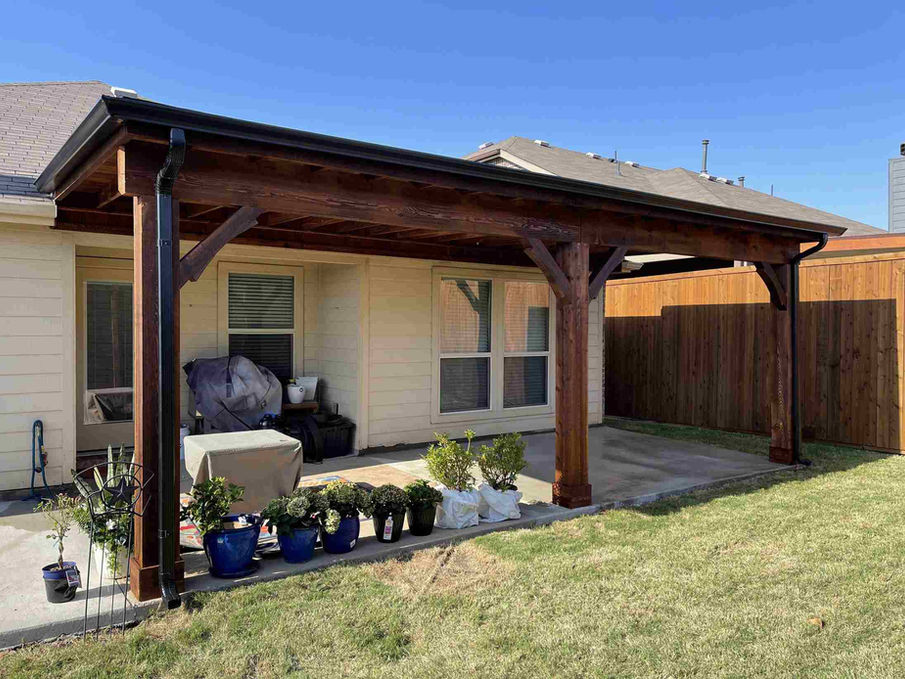 Wooden pergola cover patio, plants, and grill