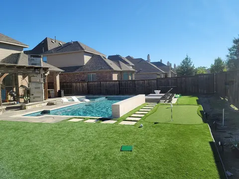 Luxury backyard oasis: Pool, putting green, patio