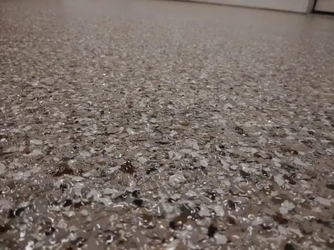 Close-up of speckled, metallic epoxy floor