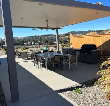 Outdoor patio with table, chairs, and grill