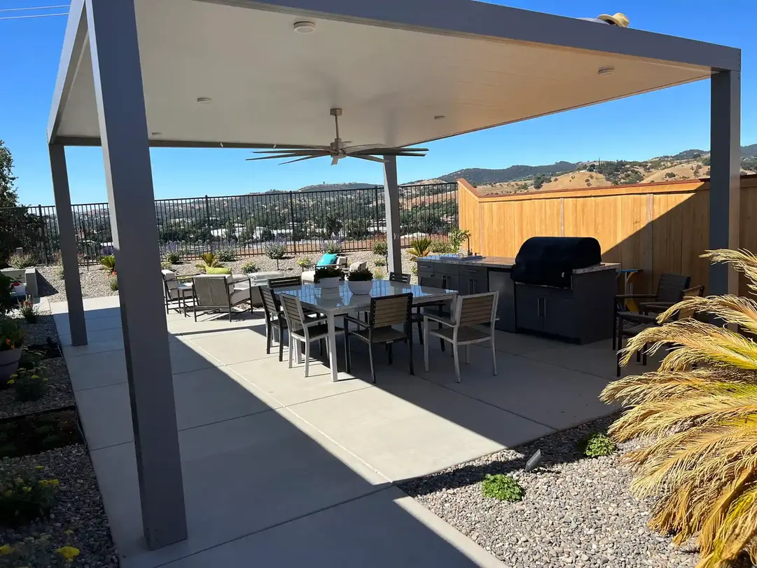 Modern pergola with outdoor dining set and grill