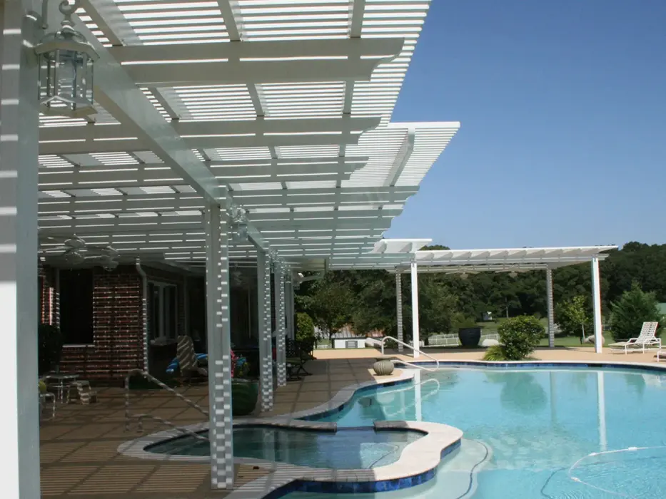 White pergola shading pool and spa area