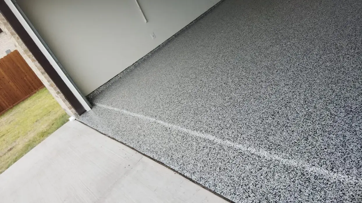 New garage floor with speckled gray epoxy coating