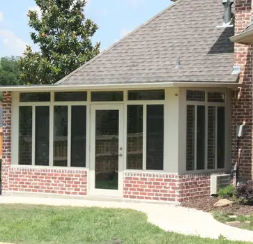 Sunroom addition to brick home with door