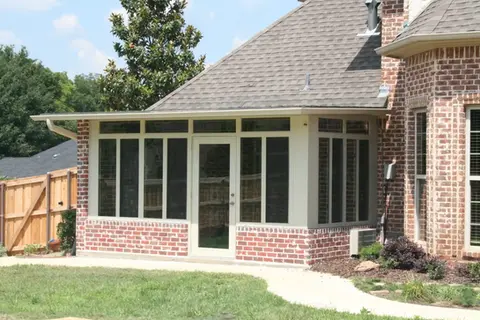 Sunroom addition to brick home with door