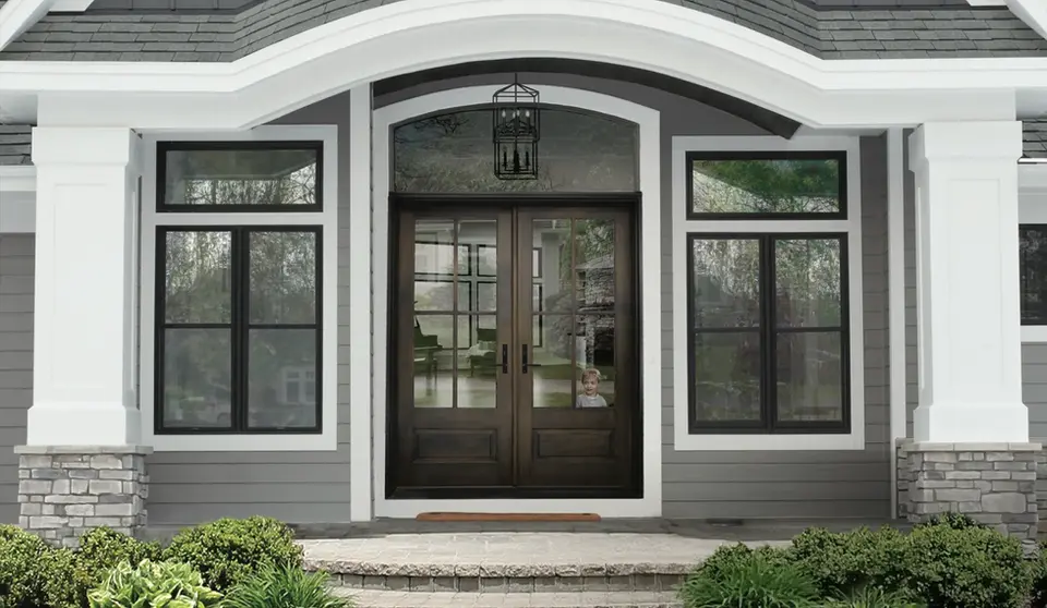 Dark brown double front doors, child visible inside, gray house