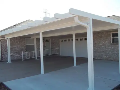 White carport cover over garage and driveway
