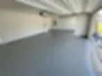 A close-up of a glossy, professionally coated garage floor that looks brand new and durable.
