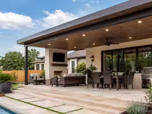 Modern covered patio with custom patio cover providing shade during a sunny Texas summer day.
