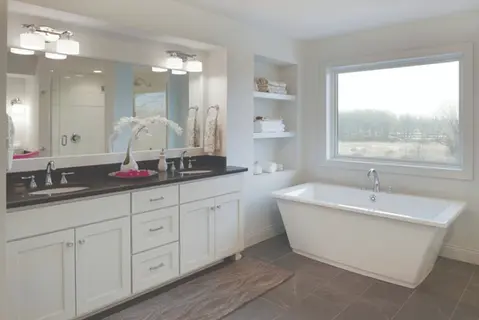Modern bathroom with double vanity, soaking tub, and natural light