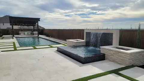 Luxury pool and spa with waterfall feature