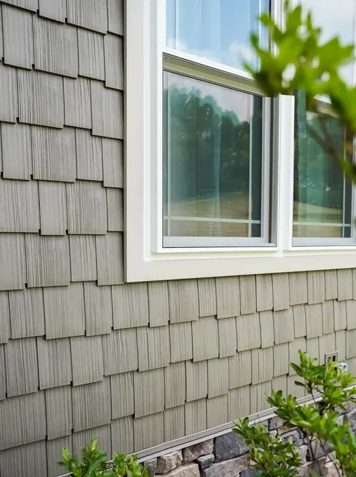 Gray shake siding with white-framed windows