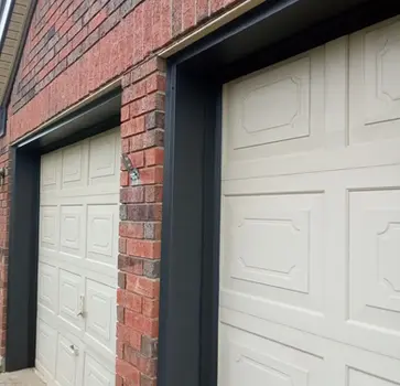 Two off-white garage doors with black frames