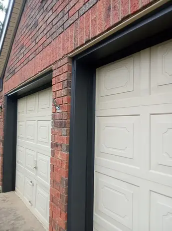 Two off-white garage doors with black frames