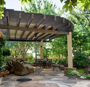 Covered patio with seating area and landscaping