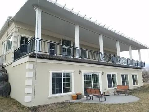 Large house with covered deck and patio