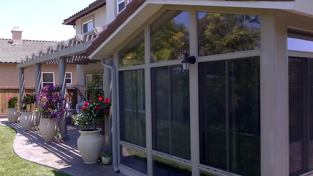 Sunroom addition with patio and pergola