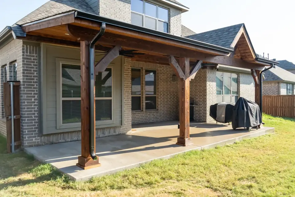 Covered patio addition to brick home