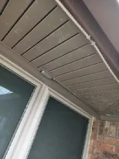 Brown wood soffit installed above window