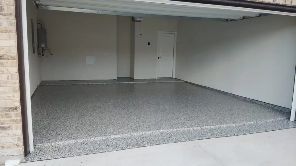 Garage with newly installed gray epoxy floor