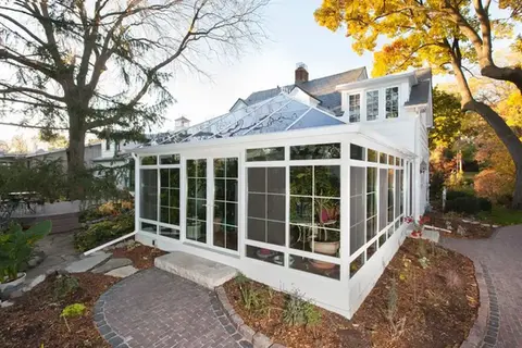 White sunroom addition attached to home