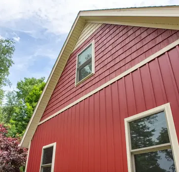 Red home exterior with white trim and windows