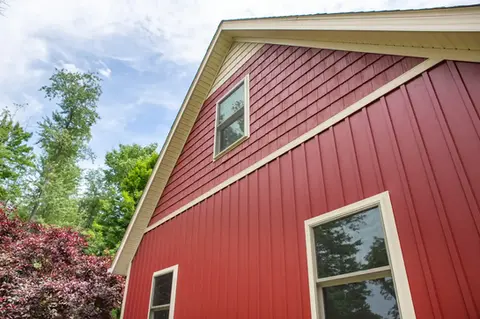 Red home exterior with white trim and windows