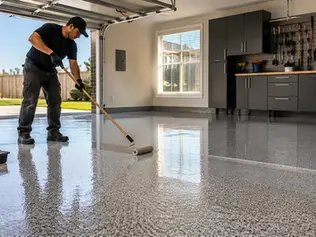 Professional applying a durable garage floor coating in a modern residential garage in DFW
