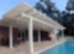 White pergola shade over patio and pool