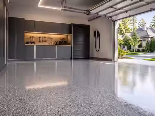 Modern garage with durable concrete floor coating in mid-grey finish with flake texture and clean lighting