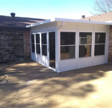 White sunroom addition with multiple windows