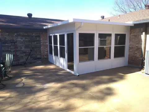 White sunroom addition with multiple windows