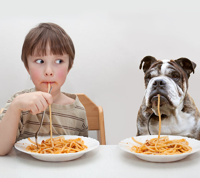 Boy and Dog Eating Pasta