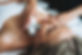 Young blonde woman enjoys facial massage with microcurrent facial massager in the spa, tre