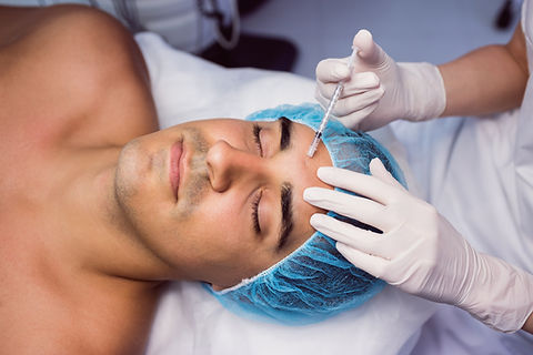 man-receiving-botox-injection-his-forehead.jpg