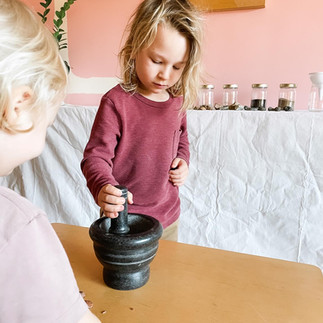 boy using pestle and mortar