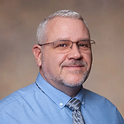 Shane Wilson Headshot Brown Background 202.png