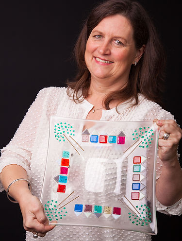 cathy displaying a bespoke glass beach hut platter