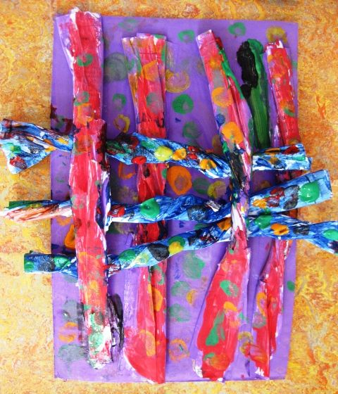 Colorful children's art project with woven paper strips on vibrant background 2
