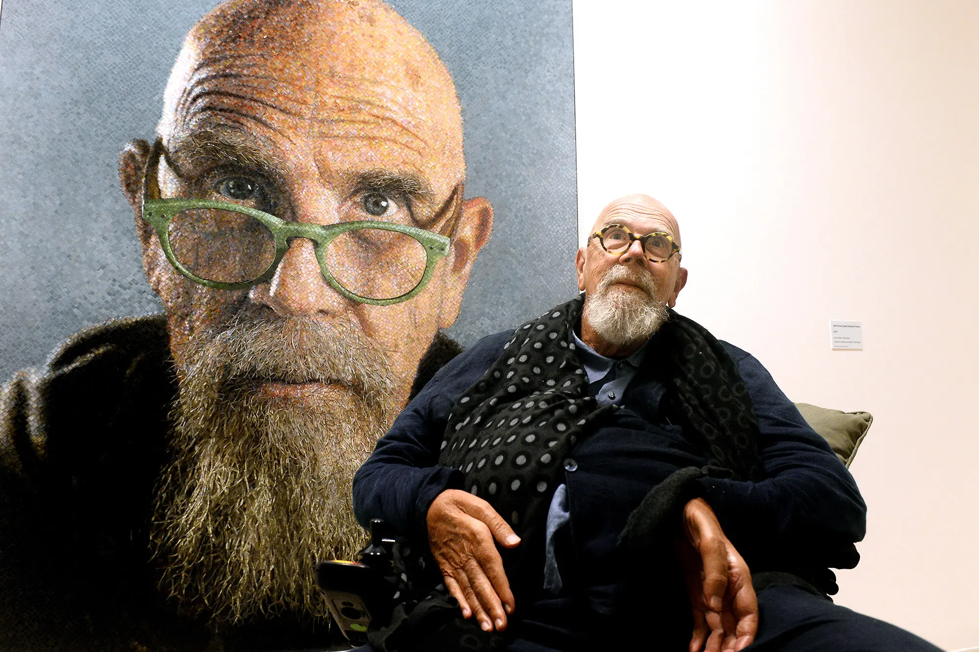 chuck close posing witht a self portrait